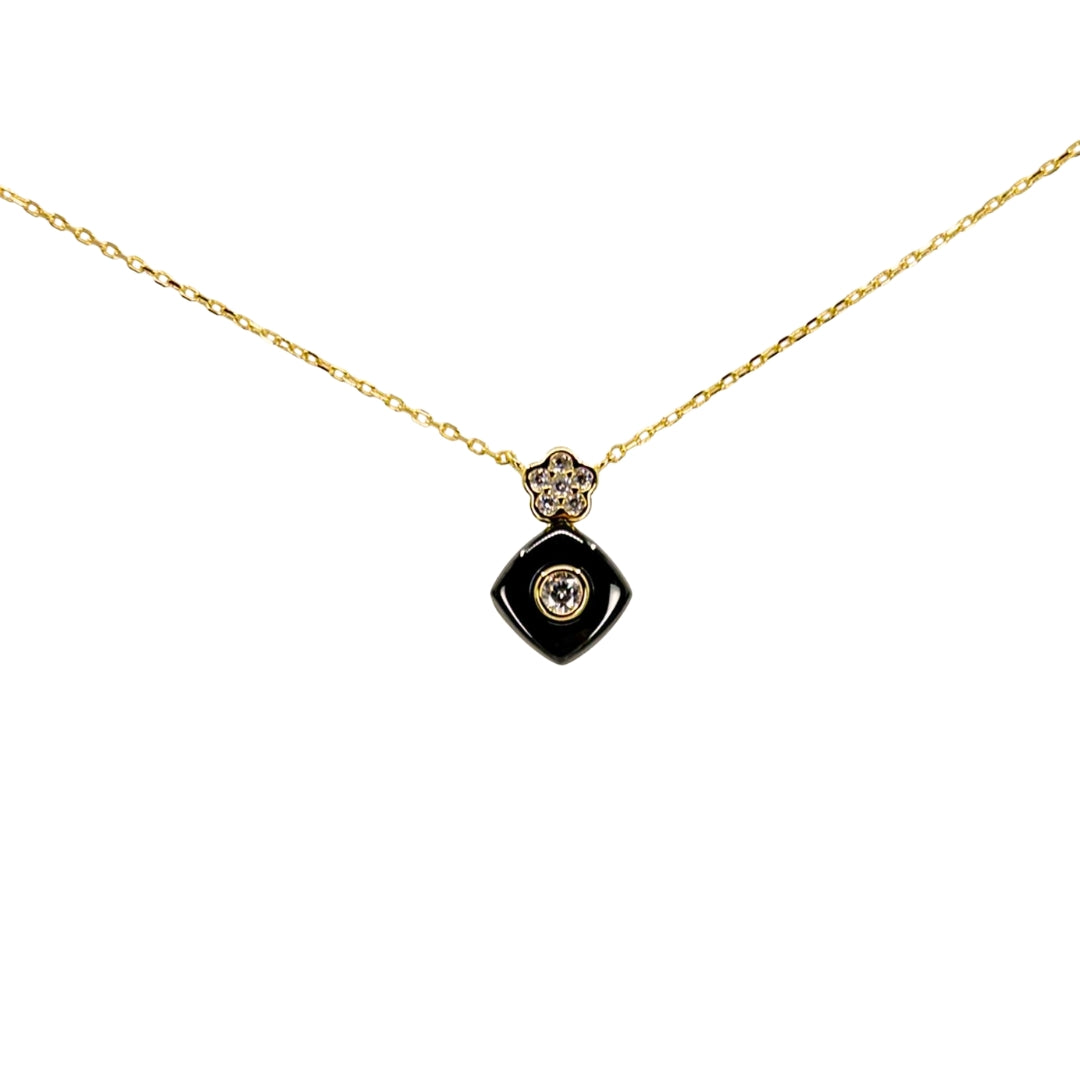 Yellow silver necklace with a black square drop pendant accented by a bezel-set cubic zirconia center.
