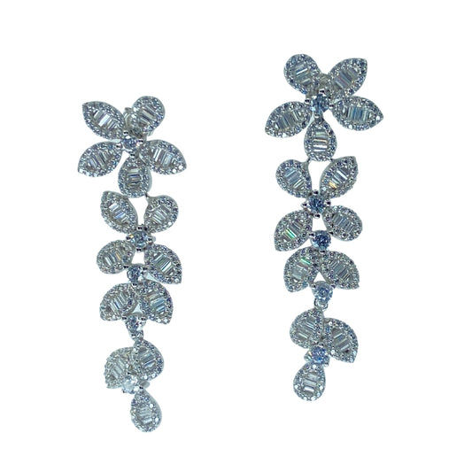 White sterling silver floral drop earrings with baguette and round cz stones in a descending vine pattern.