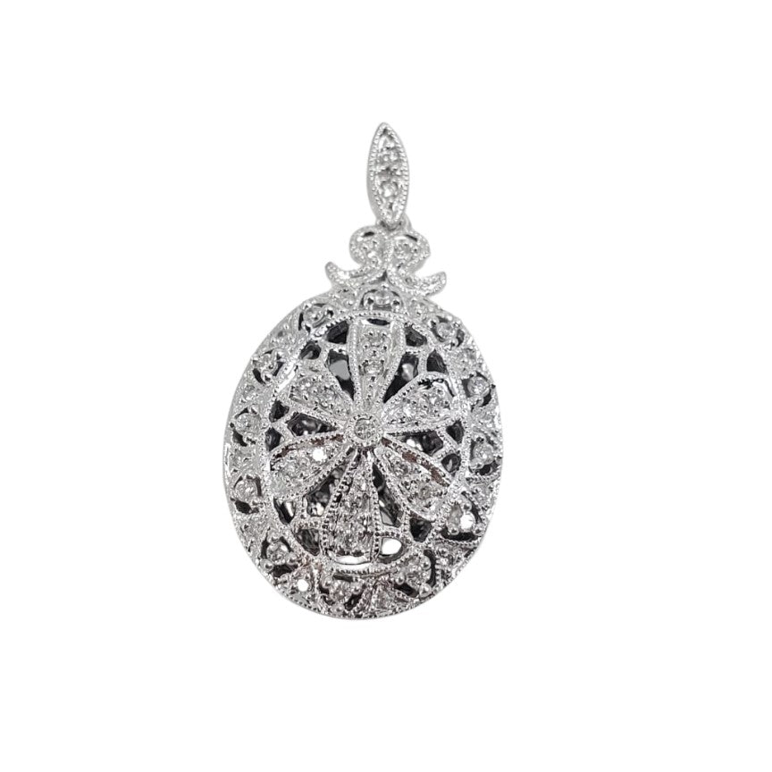 A white gold round locket with intricate filigree detailing and adorned with sparkling round diamonds.