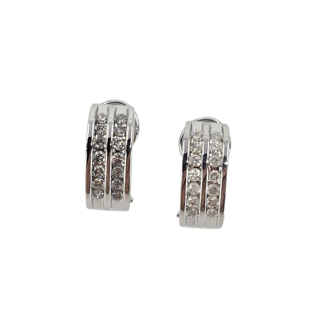 White gold half hoop earrings channel set with two rows of diamonds.
