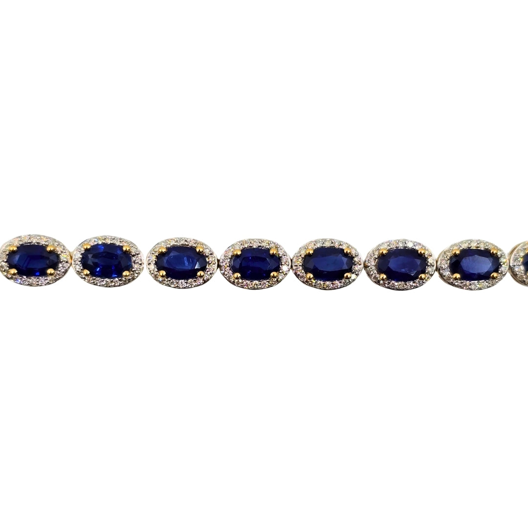 Close shot of deep blue sapphire links encircled by round diamonds.