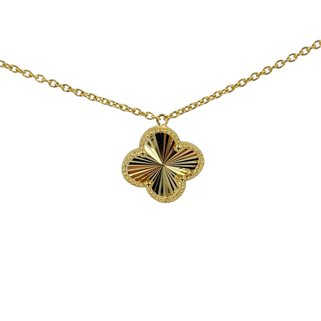 Yellow gold quatrefoil pendant with a fantasy-cut inspired design on a yellow gold chain.