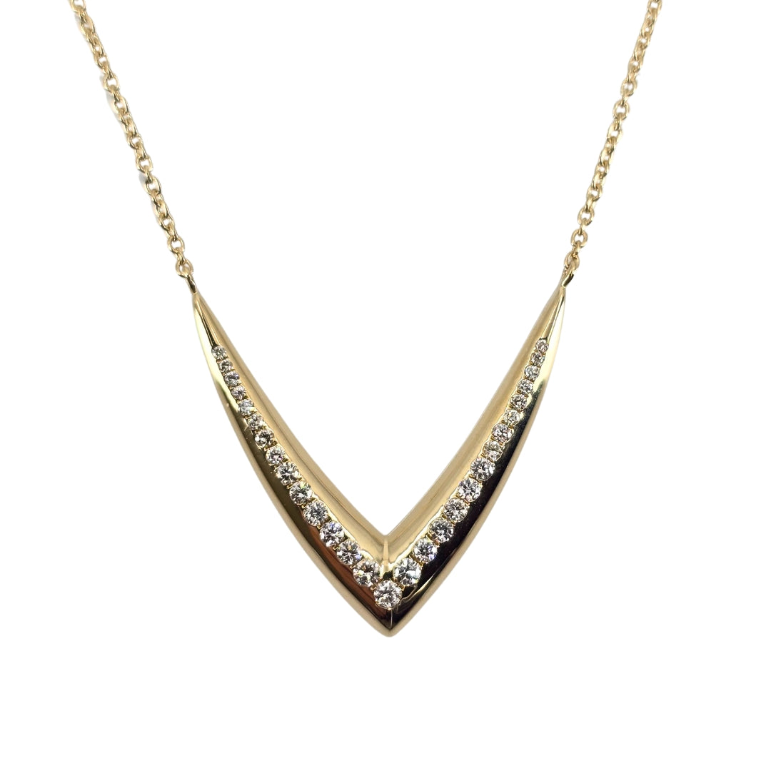 Yellow gold vee shaped necklace with a delicate vee of round diamonds in the center.