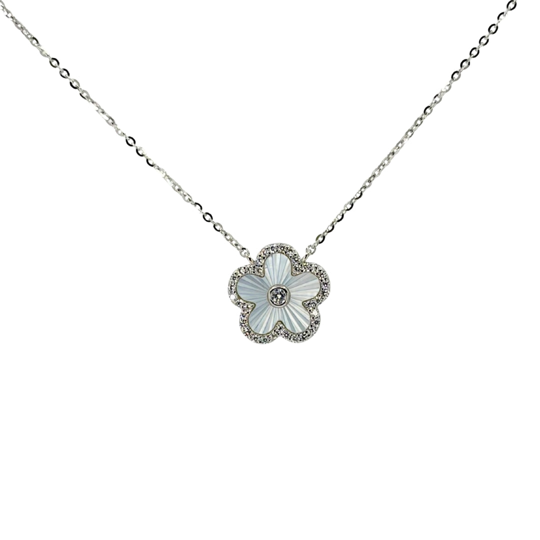 White silver necklace with a small quatrefoil pendant set with lustrous mother of pearl outlined with cz stones.