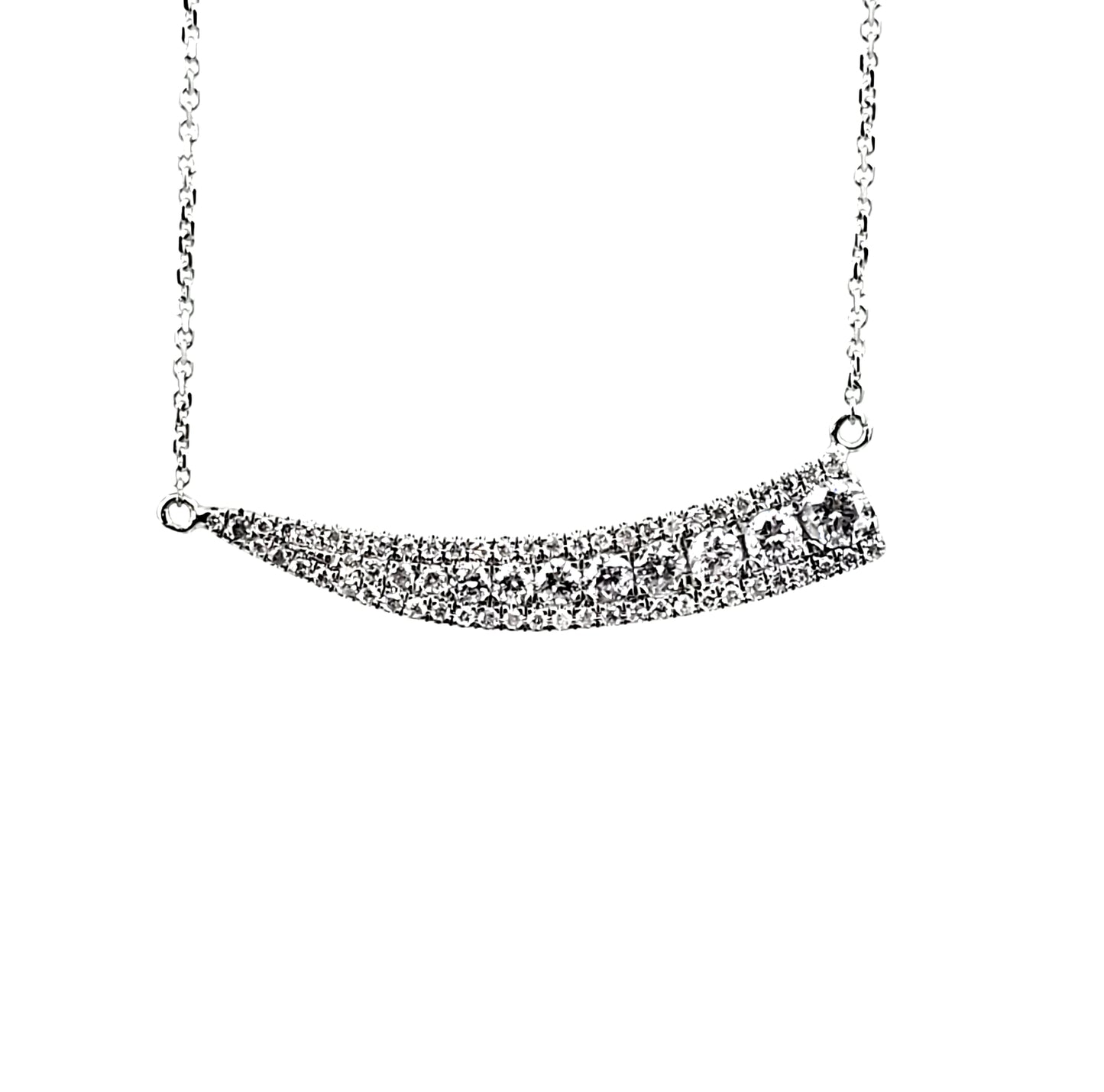 White gold necklace adorned with round diamonds that smoothly tapers as it goes right to left.