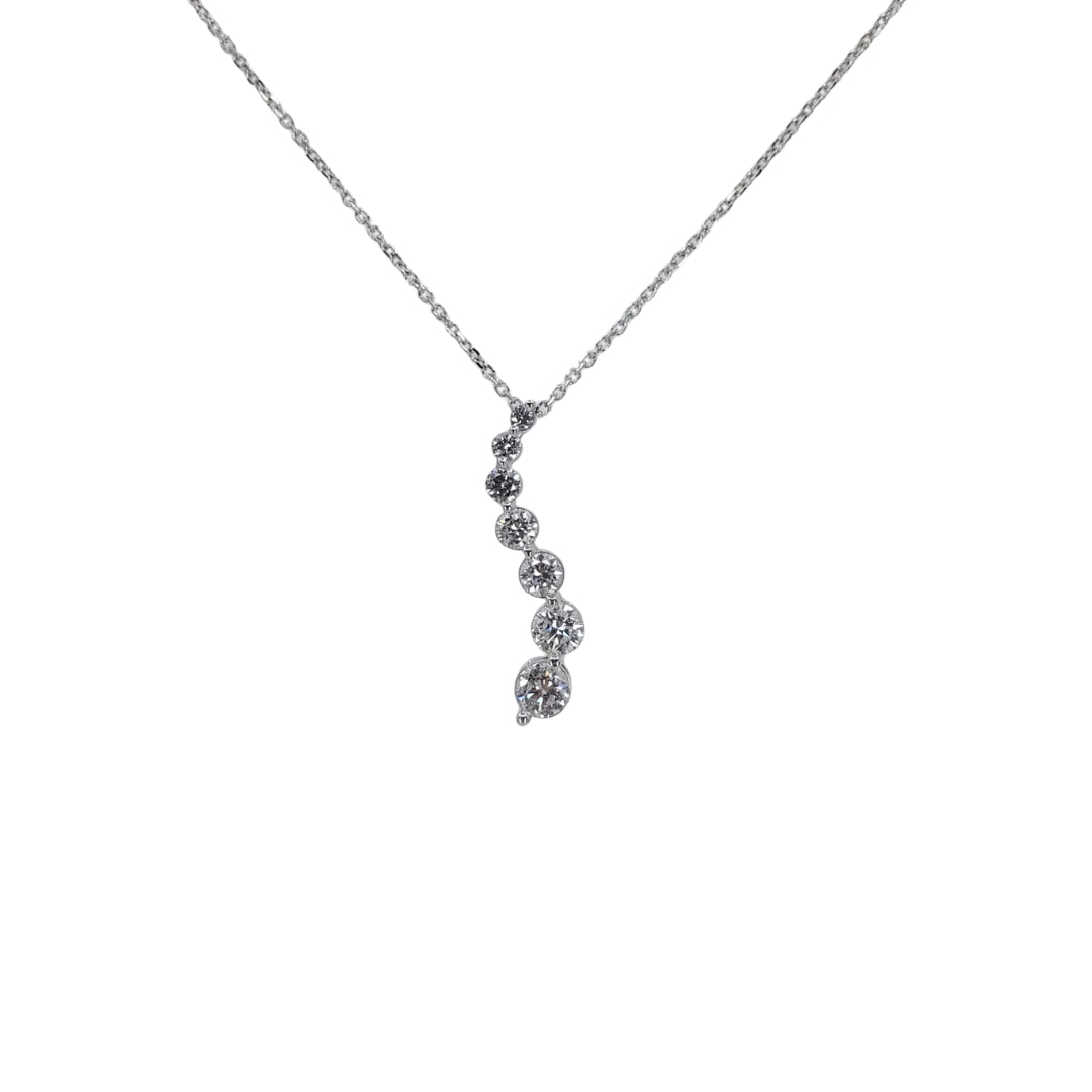 White gold diamond journey pendant suspended from a white gold chain in front of a white background.