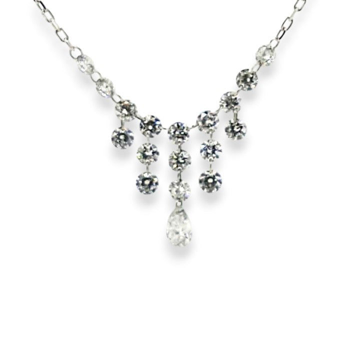Delicate white gold diamond necklace featuring hanging round stones and a central teardrop accent of a pear shaped diamond.