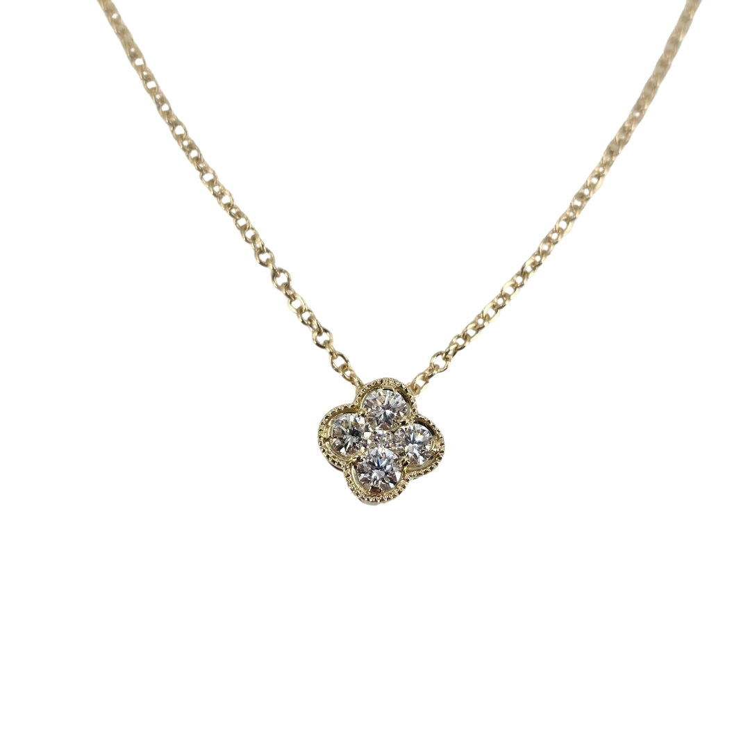 Yellow gold chain with cluster of round diamonds in a clover shape.