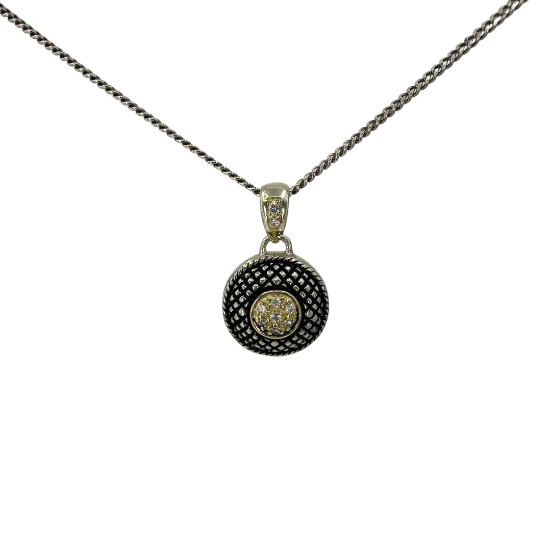 Antiqued button pendant on a white silver chain.