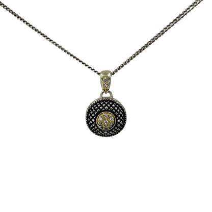 Antiqued button pendant on a white silver chain.