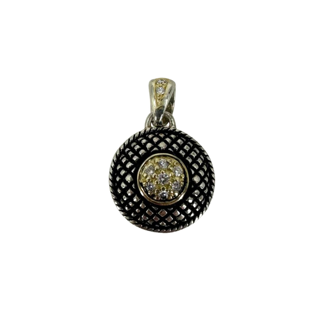 Two-tone gold and silver antiqued button pendant accented with nine round diamonds.