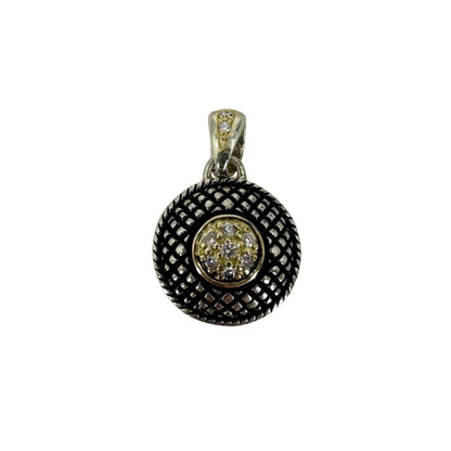 Two-tone gold and silver antiqued button pendant accented with nine round diamonds.