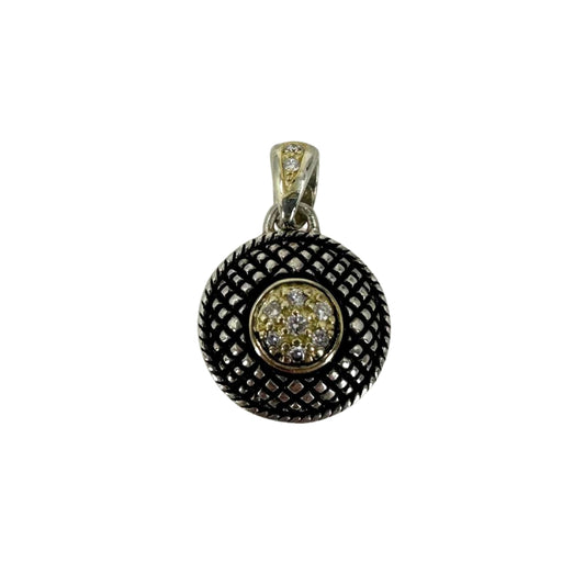 Two-tone gold and silver antiqued button pendant accented with nine round diamonds.