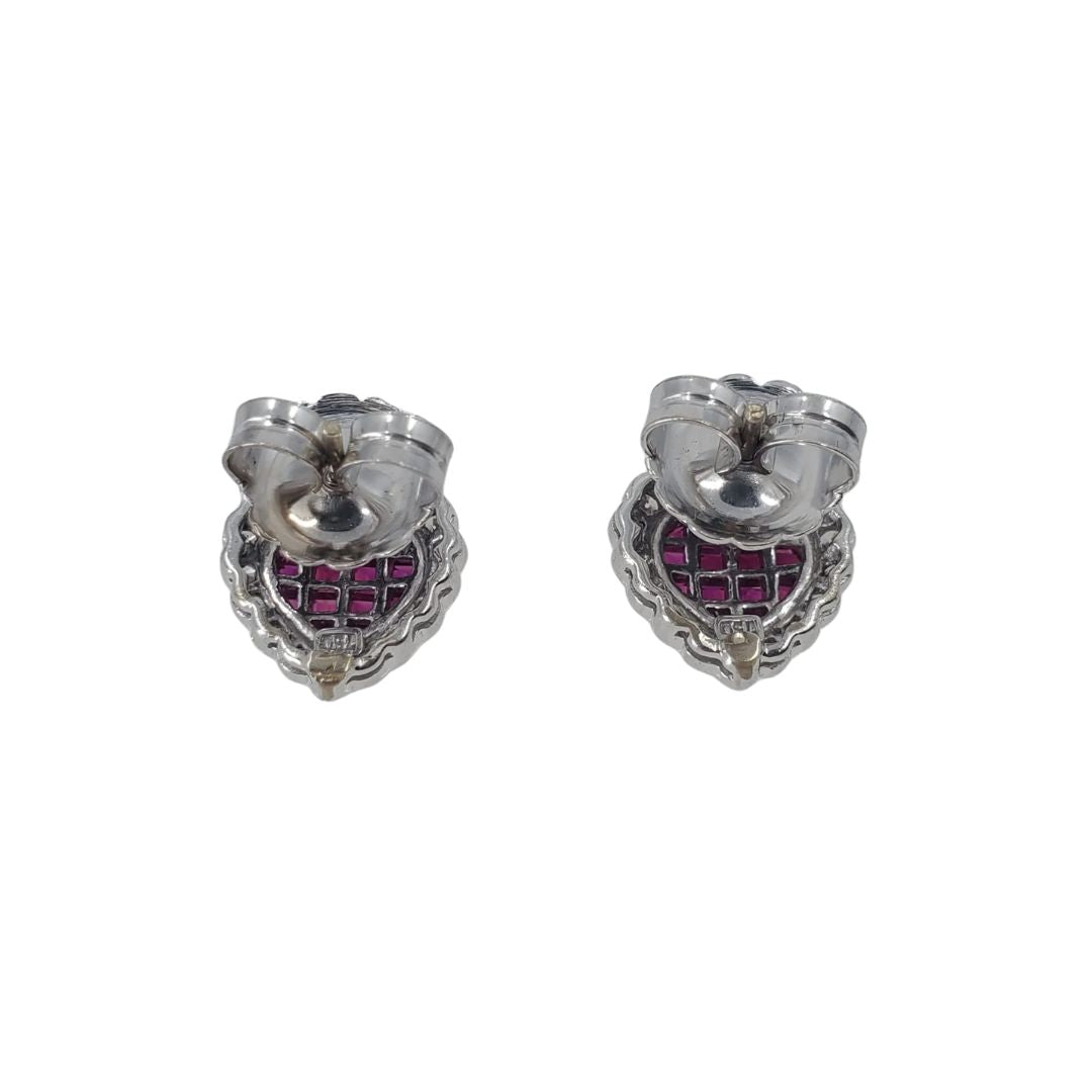 Back view of white gold heart shaped stud earrings set with a ruby center and an outer circling of diamonds.