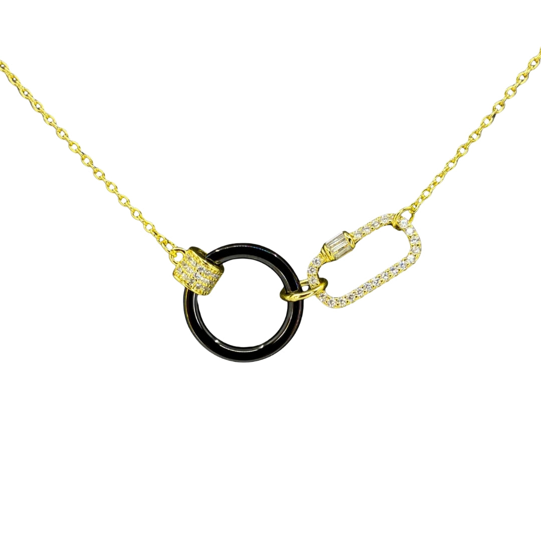Yellow silver necklace featuring a glossy black circle centerpiece linked with a cz-accented carabiner clasp.
