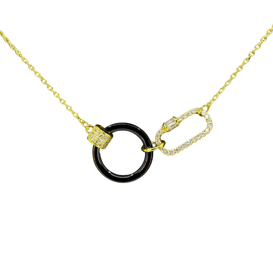 Yellow silver necklace featuring a glossy black circle centerpiece linked with a cz-accented carabiner clasp.