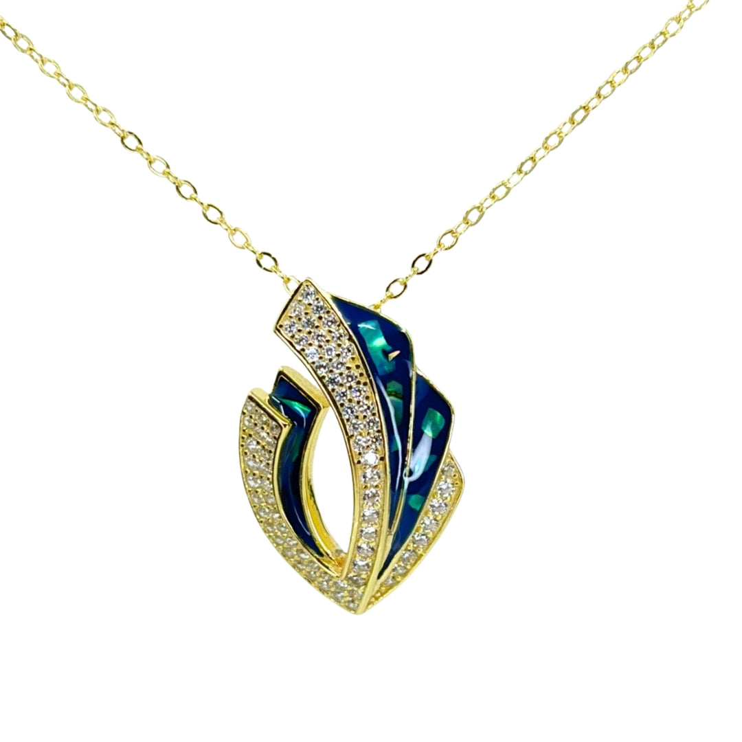 Yellow silver pendant necklace featuring layered curves with shimmering blue abalone inlay and sparkling cubic zirconia accents.
