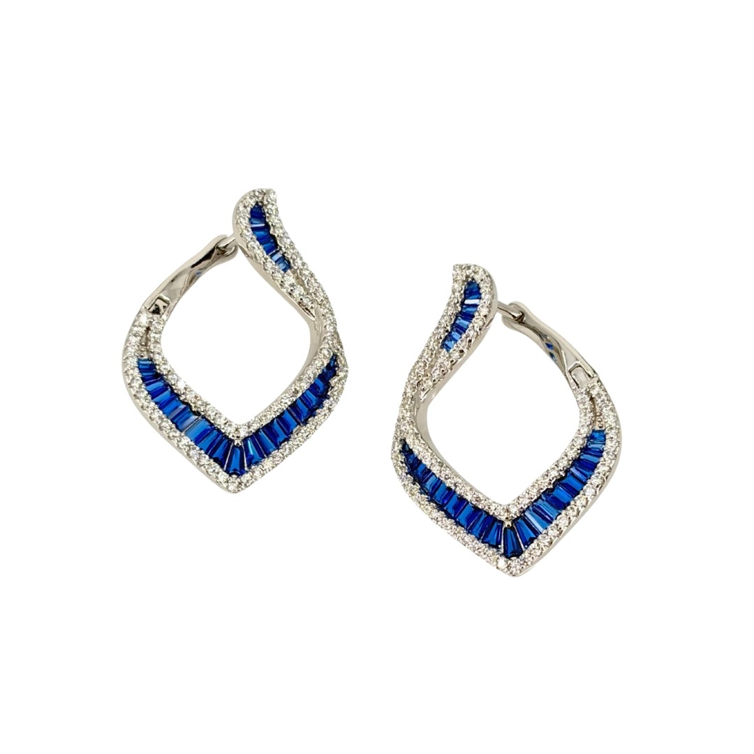 Large white silver hoop earrings set with a channel of blue baguette cz stones lined on both sides with round white cz stones.