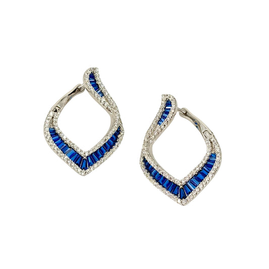Large white silver hoop earrings set with a channel of blue baguette cz stones lined on both sides with round white cz stones.