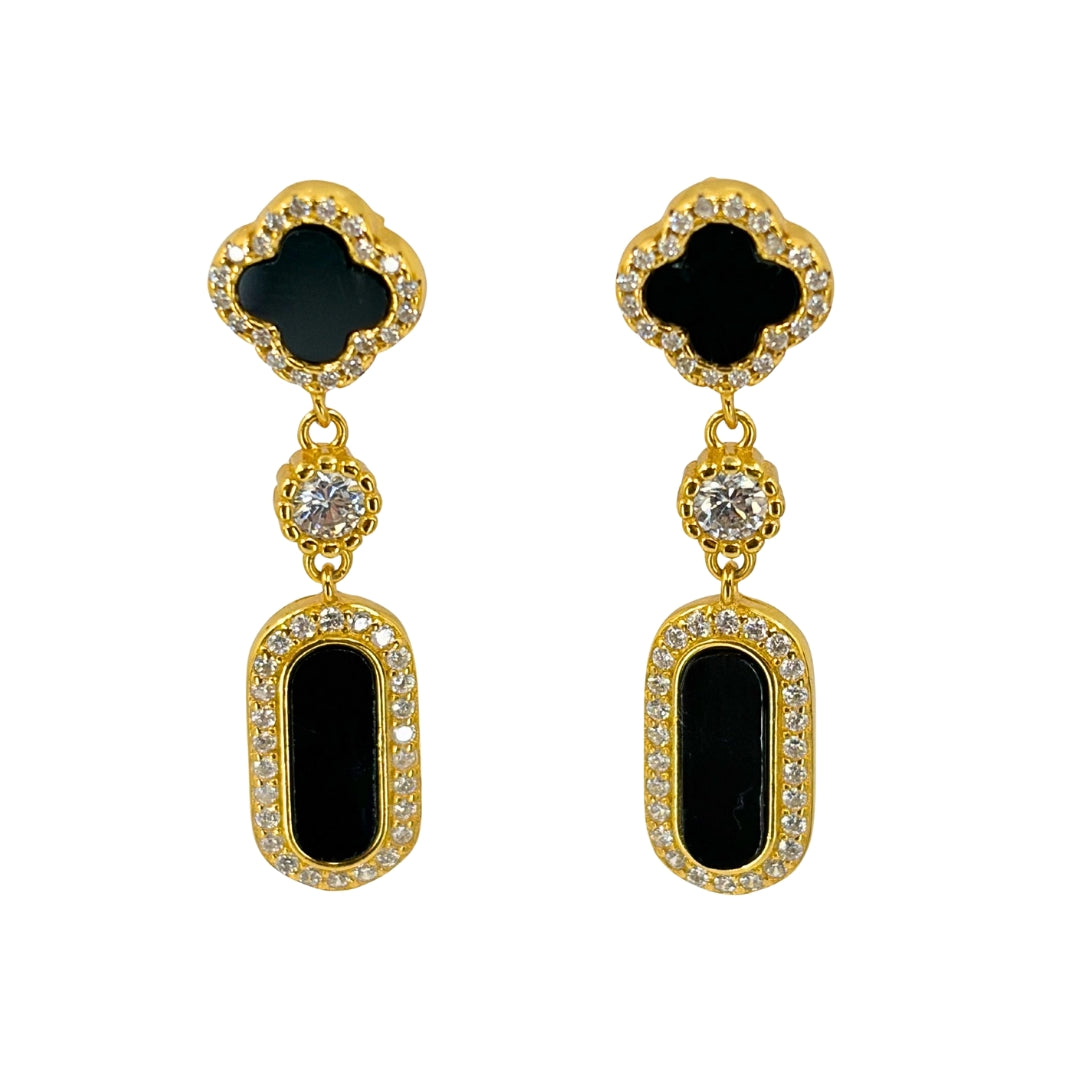 Yellow silver earrings with a clover shaped onyx stone each and a rounded rectangle onyx drop design.