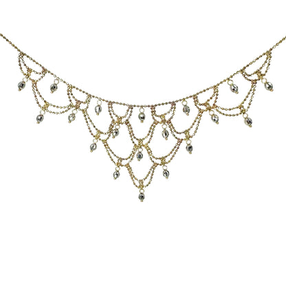 Cascading yellow gold beaded necklace with looping layers and white gold beads hanging in the loops.