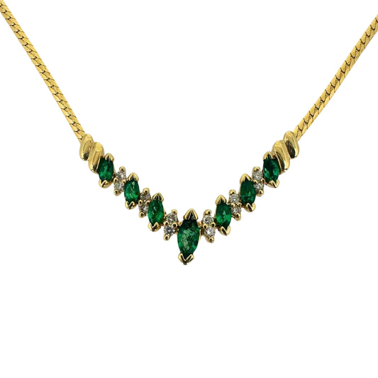 Yellow gold necklace with alternating marquise emeralds and round diamonds in a vee shape.