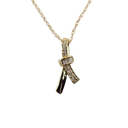 Yellow gold ribbon pendant with round diamonds along front.