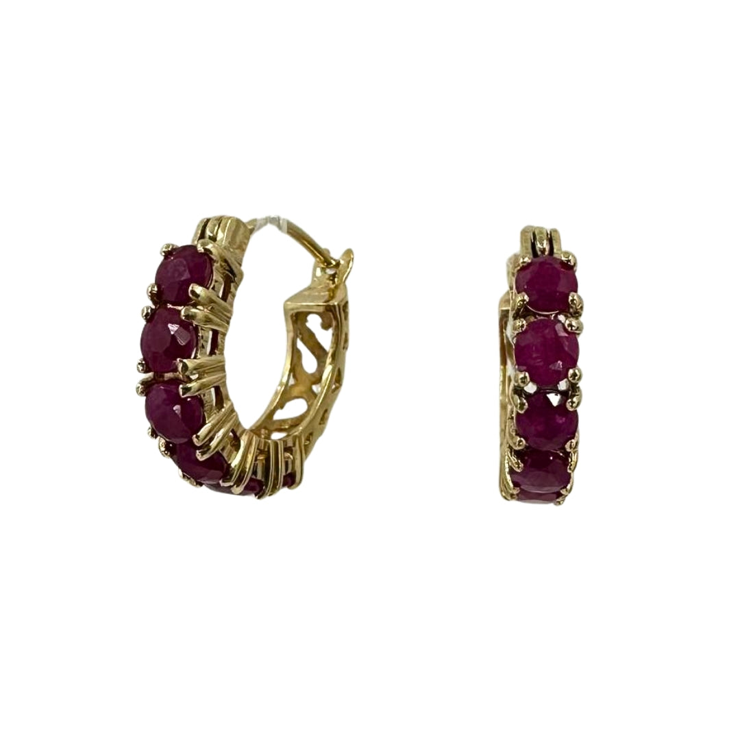 Yellow gold hoop earrings set with six brilliant round rubies each.