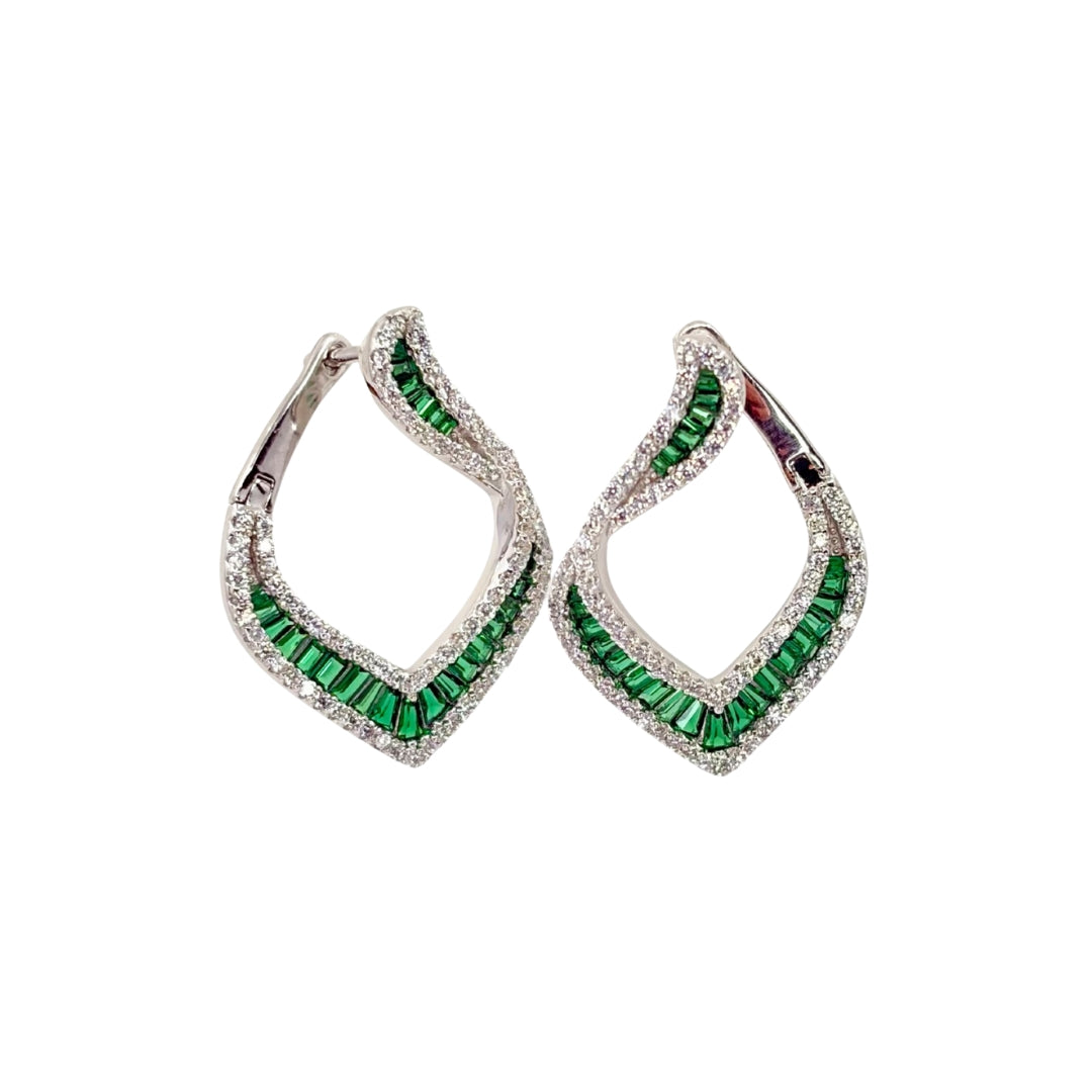 Large white silver hoop earrings with channel set green baguette cz stones accented on both sides with round white czs.