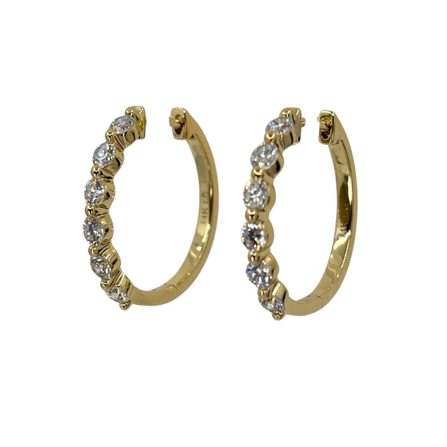 Yellow gold hoop earrings set with a line of 6 shimmering round lab grown diamond each.