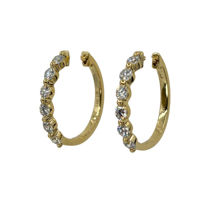 Yellow gold hoop earrings set with a line of 6 shimmering round lab grown diamond each.