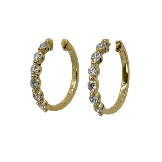 Yellow gold hoop earrings set with a line of 6 shimmering round lab grown diamond each.
