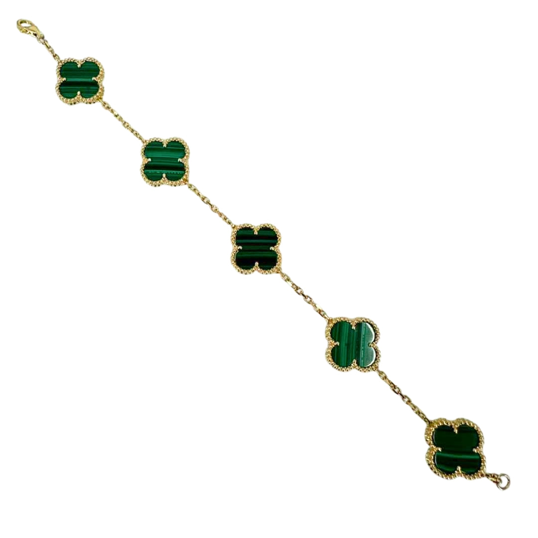 Yellow gold 7 inch bracelet extended diagonally showcasing its 5 vibrant green malachite quatrefoils.