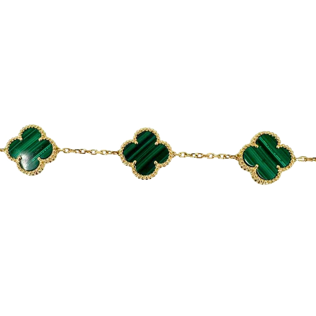 Yellow gold bracelet with vibrant quatrefoil shaped malachite stones.