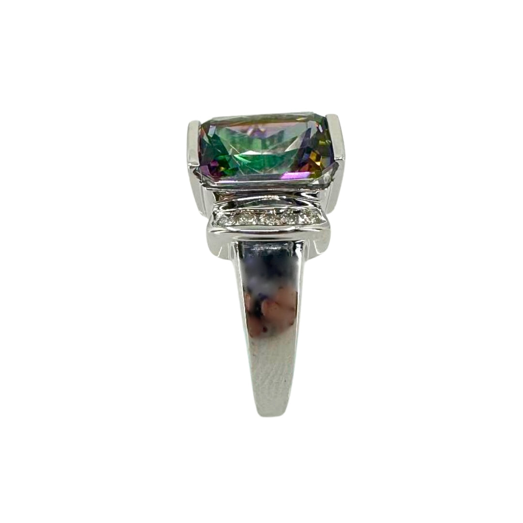 White gold ring with a polished shank a central vibrant mystic topaz stone accented on the side with brilliant round diamonds.