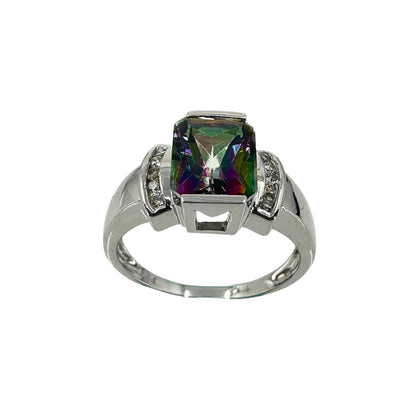 White gold ring set with a central radiant-cut mystic topaz stone with vibrant cool colors and accented with a setting of round diamonds on either side.