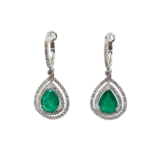 Drop earrings with bright pear emeralds and a double diamond halo set in white gold.