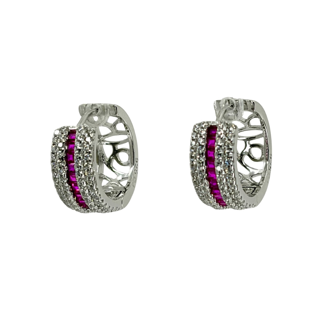 White silver huggy earrings adorned with a channel of red cz stones encased with 2 rows of white cz stones.