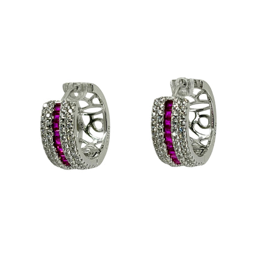 White silver huggy earrings adorned with a channel of red cz stones encased with 2 rows of white cz stones.