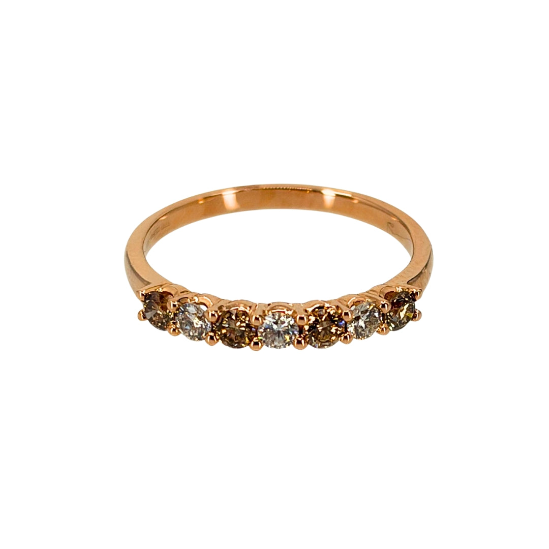 Rose gold band set with alternating desert and white diamonds totaling 7 sparkling stones.