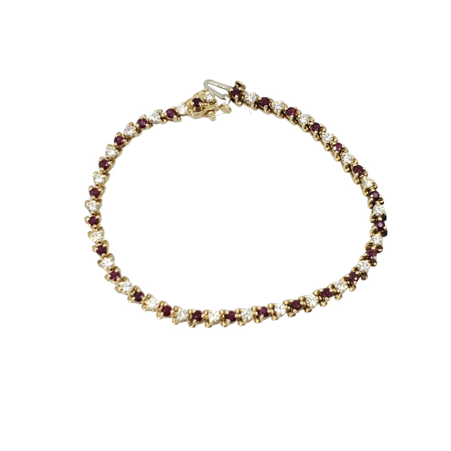 Yellow gold tennis bracelet featuring alternating round diamonds and rubies in 3-prong settings.