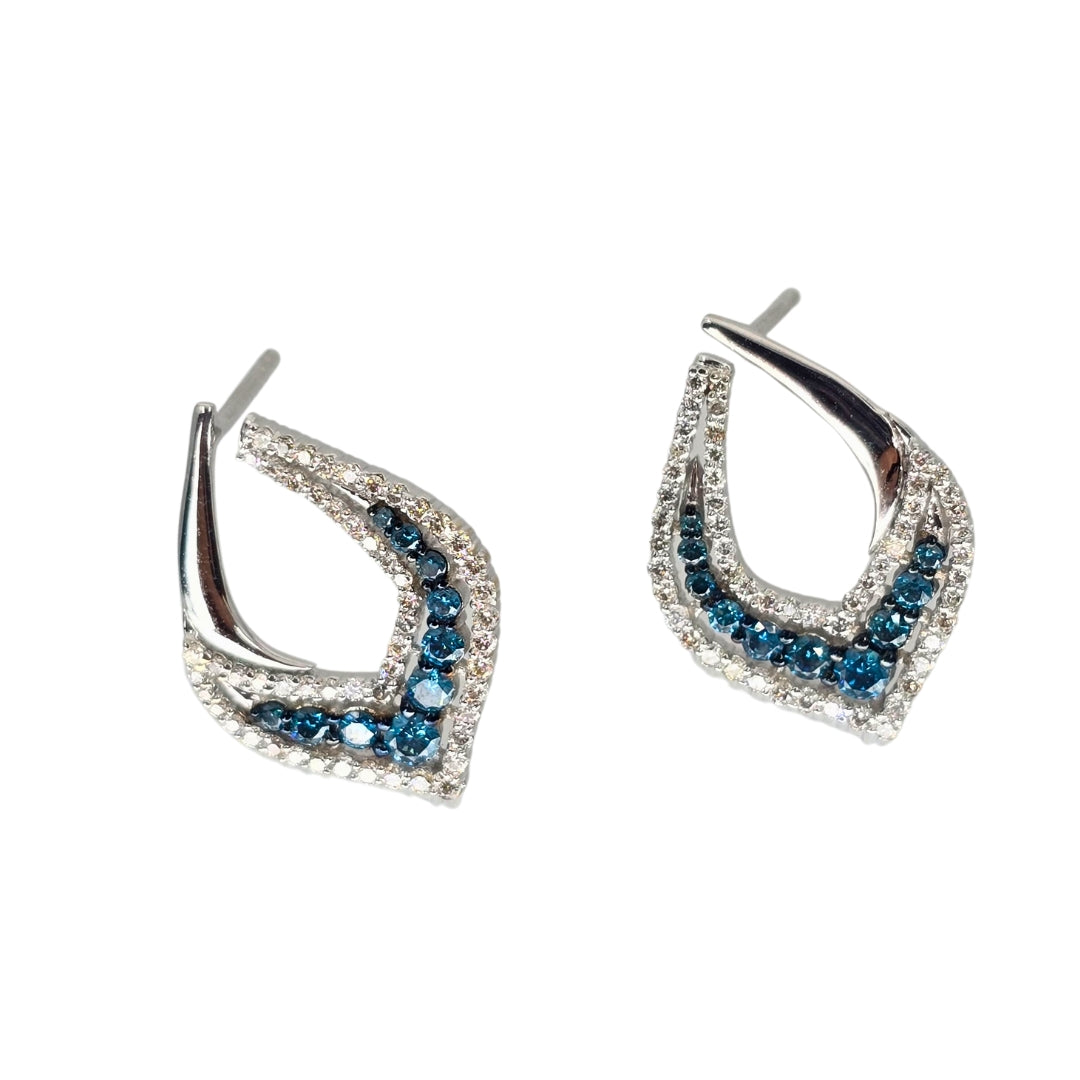 Side view of white gold earrings set with bright blue and white diamonds.
