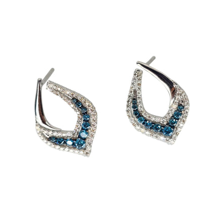 Side view of white gold earrings set with bright blue and white diamonds.