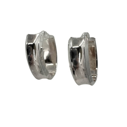 Wide white silver hoop earrings in an oval shape with a concave design.
