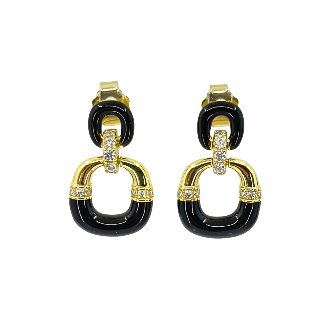 Yellow silver earrings with two descending ovals connected by a cz covered bail and black enamel detailing on the lower half of the ovals.