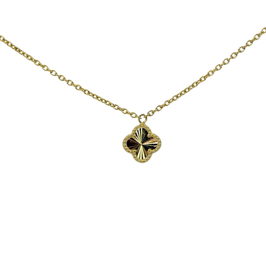 Yellow gold necklace with a dainty gold quarefoil pendant.