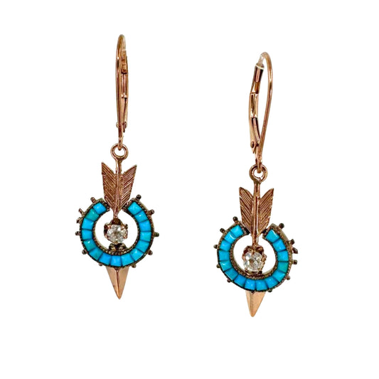 Rose gold drop earrings with a downward arrow design centering a firey old mine cut diamond and a halo of vibrant turquoise stones.