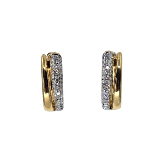 Round diamond double hoop earrings crafted from two tone gold.