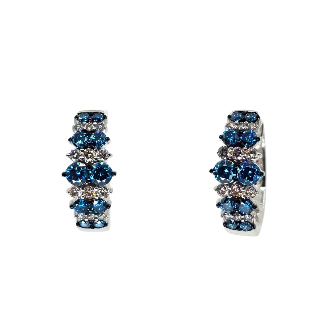 White gold hoop earrings set with alternating stripes of blue and white diamonds.