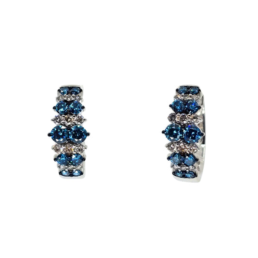 White gold hoop earrings set with alternating stripes of blue and white diamonds.